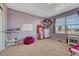 Charming bedroom with a large window, playful decor, and comfortable carpet flooring at 55610 E 40Th Ave, Strasburg, CO 80136