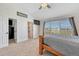 Bright bedroom with a large window offering scenic views and easy access to the bathroom and closet at 55610 E 40Th Ave, Strasburg, CO 80136