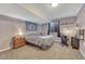Cozy bedroom with soft lighting, a comfortable bed, desk area and carpet flooring at 55610 E 40Th Ave, Strasburg, CO 80136