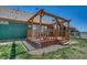 Exterior view of deck with pergola and railing overlooking the backyard and landscaping at 55610 E 40Th Ave, Strasburg, CO 80136