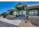 Inviting covered front porch with a cozy seating area and natural wood beams at 55610 E 40Th Ave, Strasburg, CO 80136