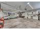 Bright, oversized garage with a classic car, storage cabinets, and work benches perfect for hobbies at 55610 E 40Th Ave, Strasburg, CO 80136