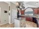 This open kitchen features a functional center island, great natural light, and stainless appliances at 55610 E 40Th Ave, Strasburg, CO 80136