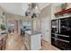 Bright kitchen featuring a center island, stainless refrigerator, and an open view to the dining area at 55610 E 40Th Ave, Strasburg, CO 80136