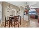 Combined kitchen and dining space with island, pot rack, and bright natural light at 55610 E 40Th Ave, Strasburg, CO 80136