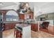 Spacious kitchen features a center island with seating, stainless appliances, and large arched window at 55610 E 40Th Ave, Strasburg, CO 80136