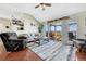 Comfortable living area featuring hardwood floors, neutral decor, and sliding glass door to deck at 55610 E 40Th Ave, Strasburg, CO 80136