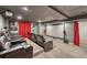 Home theater room with comfortable seating, tiered levels, and a large screen for entertainment at 55610 E 40Th Ave, Strasburg, CO 80136
