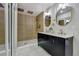 Modern bathroom featuring a double sink vanity, mirrors, and a tiled shower with a rainfall shower head at 10508 W Chautauga Mtn, Littleton, CO 80127
