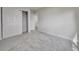 Bedroom featuring plush carpet, neutral paint, a closet with sliding doors, and access to hallway at 10508 W Chautauga Mtn, Littleton, CO 80127
