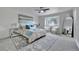 Bright bedroom featuring an area rug, ceiling fan, accent seating and a large mirror at 10508 W Chautauga Mtn, Littleton, CO 80127