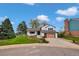Charming home boasts a well-manicured lawn and modern garage door at 10508 W Chautauga Mtn, Littleton, CO 80127