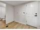 Laundry area displaying wood-look tile floor, utility hook-ups, and white door to basement at 10508 W Chautauga Mtn, Littleton, CO 80127