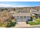 Aerial shot of a residential neighborhood showcasing a well-maintained home with a spacious driveway and garages at 9759 Lane St, Thornton, CO 80260