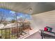 Balcony with railing offers an outdoor space with views of neighborhood homes and trees at 9759 Lane St, Thornton, CO 80260