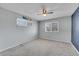 This empty bedroom features soft gray walls, a ceiling fan, and natural lighting from the windows at 9759 Lane St, Thornton, CO 80260