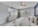 Comfortable bedroom featuring two large windows, light gray walls, and soft carpet at 9759 Lane St, Thornton, CO 80260
