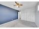 This empty bedroom has plenty of storage with a full wall of closet space and a ceiling fan at 9759 Lane St, Thornton, CO 80260