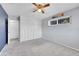 This empty bedroom has a ceiling fan, window, and large closet for storage at 9759 Lane St, Thornton, CO 80260