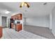 Open concept kitchen and living area featuring modern appliances and tile flooring at 9759 Lane St, Thornton, CO 80260