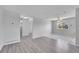 Open-concept living space with wood-look and tiled flooring and a ceiling fan at 9759 Lane St, Thornton, CO 80260