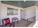 Small patio features a chair with a red pillow, a table, and a view from the back of the house at 9759 Lane St, Thornton, CO 80260