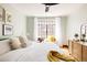 Bright bedroom featuring a large window with window seat, soft pillows, and stylish furnishings at 1060 N Washington St # 301, Denver, CO 80203
