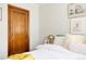 Bedroom features a wooden door and hardwood floors and a large soft bed with pillows at 1060 N Washington St # 301, Denver, CO 80203