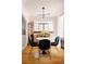 Sunlit dining area featuring hardwood floors, modern lighting, and a round table for intimate gatherings at 1060 N Washington St # 301, Denver, CO 80203