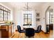 Bright dining space with hardwood floors, stylish seating, and plenty of natural light from large windows at 1060 N Washington St # 301, Denver, CO 80203