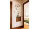 Hallway features a decorative wall clock, a small display shelf, and a view into the bedroom at 1060 N Washington St # 301, Denver, CO 80203