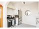 Modern kitchen with stainless steel appliances, white cabinets, and stylish black and white flooring at 1060 N Washington St # 301, Denver, CO 80203