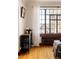 Bright living room with hardwood floors, large window, and charming bar cabinet at 1060 N Washington St # 301, Denver, CO 80203