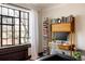 Bright office space with large window, minimalist desk, and ample shelving at 1060 N Washington St # 301, Denver, CO 80203