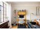 Bright office with large windows, minimalist desk, and ample book storage at 1060 N Washington St # 301, Denver, CO 80203