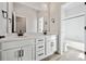 Bright bathroom featuring double sink vanity, large mirror and shower at 13710 Emerald Lake St, Parker, CO 80138