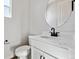 Modern half bathroom with white vanity, quartz counters, and sleek fixtures at 13710 Emerald Lake St, Parker, CO 80138