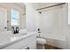 Modern bathroom with white cabinetry, black fixtures, and bathtub with white tiled walls at 13710 Emerald Lake St, Parker, CO 80138