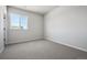 Bright bedroom features neutral walls, carpeted flooring, and natural light through a window at 13710 Emerald Lake St, Parker, CO 80138