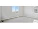 Bright bedroom with neutral carpet, large windows, and ample natural light at 13710 Emerald Lake St, Parker, CO 80138