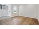 A light-filled empty bedroom featuring wood flooring and a window at 13710 Emerald Lake St, Parker, CO 80138