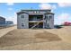 New construction with a modern gray exterior, backyard, and a second-story covered deck at 13710 Emerald Lake St, Parker, CO 80138