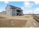New construction with a modern gray exterior, backyard, and a second-story covered deck at 13710 Emerald Lake St, Parker, CO 80138