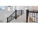 Bright hallway featuring black metal railings with carpeted floors and natural light at 13710 Emerald Lake St, Parker, CO 80138