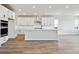 Bright, open kitchen with white cabinets, stainless steel appliances, and large island at 13710 Emerald Lake St, Parker, CO 80138
