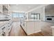 Open-concept kitchen featuring white cabinets, stainless appliances, and seamless flow into living area at 13710 Emerald Lake St, Parker, CO 80138