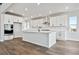 Bright, open kitchen with white cabinets, stainless steel appliances, and large island at 13710 Emerald Lake St, Parker, CO 80138