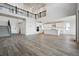 A modern living room boasts a spacious layout, an abundance of natural light, and stylish wood flooring at 13710 Emerald Lake St, Parker, CO 80138