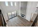 Spacious living room with tall ceilings, a fireplace, wood floors, and an outdoor patio at 13710 Emerald Lake St, Parker, CO 80138