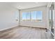 Bright, neutral living room with large windows offering scenic views and ample natural light at 13710 Emerald Lake St, Parker, CO 80138